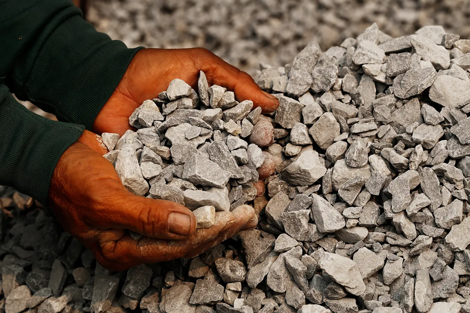 Closeup shot of coal miner in the man hands of the working. concept about coal mining for the generation of electricity worldwide, Used as fuel for industrial coal.  Volcanic rock.